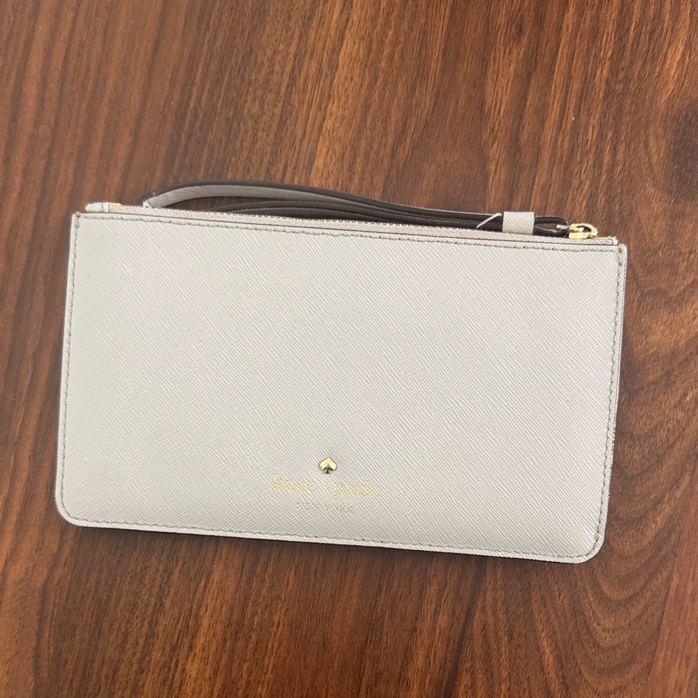 kate spade light gray saffiano leather wristlet with gold logo